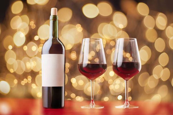bottle of wine and wine glasses on the festive table . - Photo, Image