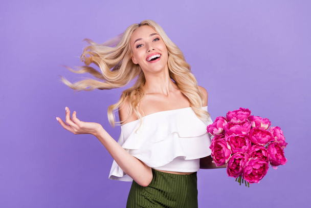 Photo of cheerful positive lady enjoy summer hold bunch peonies wear white blouse isolated purple color background - Foto, Imagem