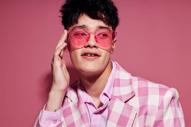A young man plaid blazer pink glasses fashion modern style pink background unaltered - Foto, imagen