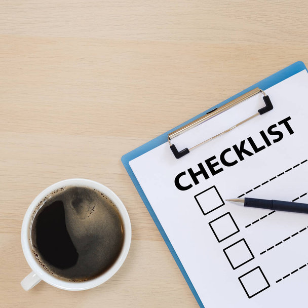 checklist box on clipboard with pen and coffee cup on wooden table. check choice answer test. checklist information writing. - Foto, immagini