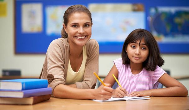 Ensinar é a paixão dela. Tiro de uma professora ajudando seu aluno com seu trabalho na sala de aula. - Foto, Imagem
