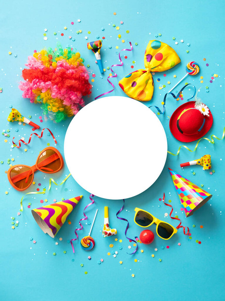 Colorful party items for carnival or birthday party on blue background with copy space - Foto, imagen