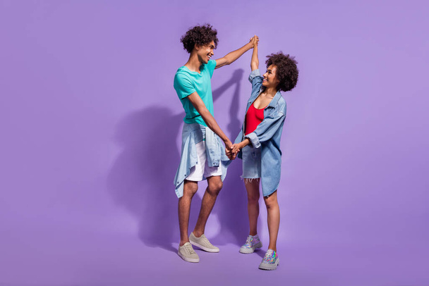 Full length photo of funky joyful dark skin couple dance good mood summer isolated on purple color background - Photo, image
