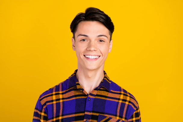 Photo of nice brunet young guy wear plaid shirt isolated on yellow color background - Foto, Imagem