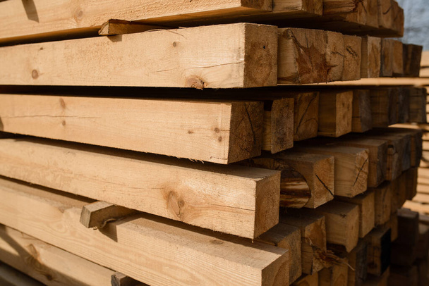 Wood background. Pile of planks. Warehouse wood storage for sawing boards. Wood timber stack of wooden blanks.  - Foto, imagen
