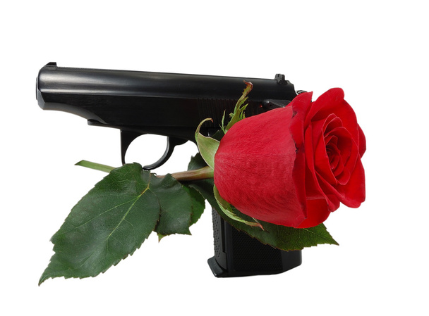 πιστόλι και ένα κόκκινο τριαντάφυλλο - Φωτογραφία, εικόνα
