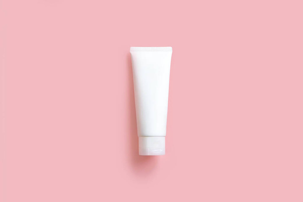 Top view of mockup model of white squeeze bottle cream tube on pink background. Plastic flacon for body lotion, toiletry. Container for cosmetics product. Skincare, advertising concept. Mockup style. - Photo, Image