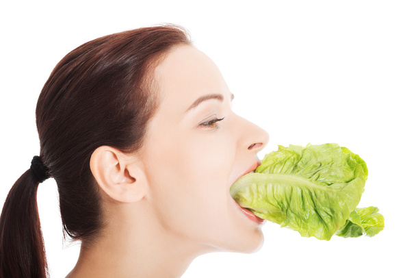 Smiling woman eating salat - Foto, Imagen