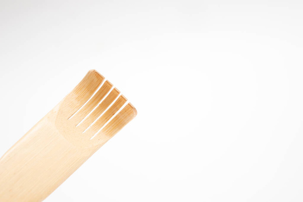 Wooden scratching stick on white background. - Photo, Image