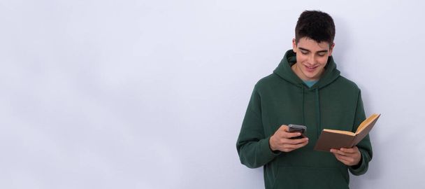 isolated teenager with mobile phone and book - Photo, Image