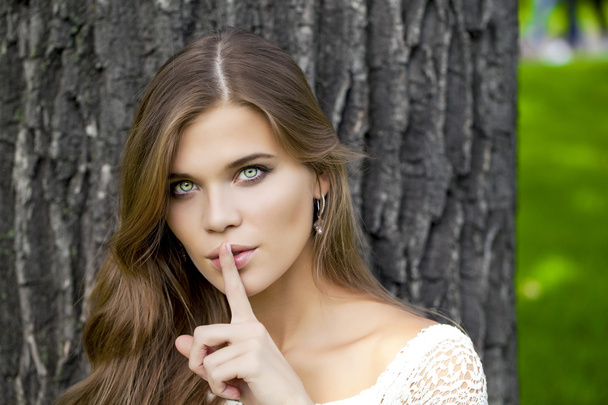 Woman has put forefinger to lips as sign of silence - Foto, Imagem