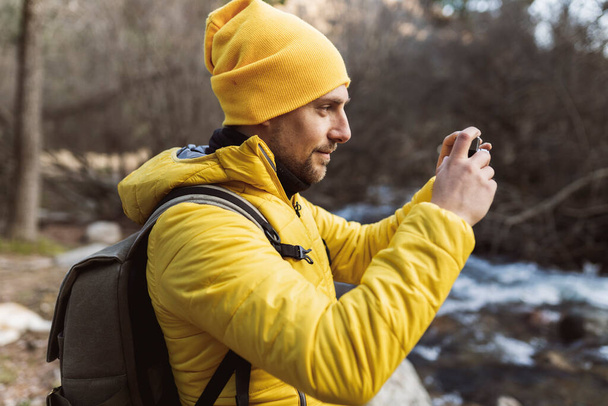 Backpacker traveler on trekking taking photos with camera - Foto, imagen