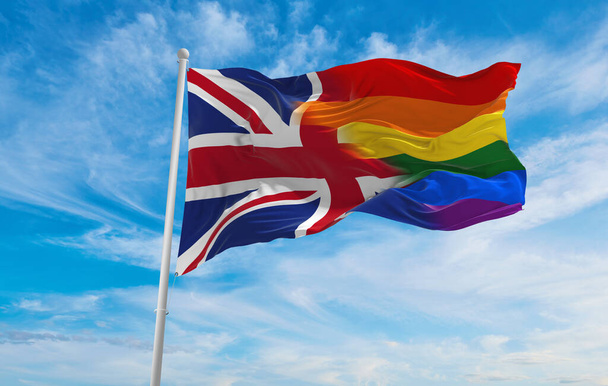 national lgbt flag of Great Britain flag waving in the wind at cloudy sky. Freedom and love concept. Pride month. activism, community and freedom Concept. Copy space. 3d illustration - Zdjęcie, obraz