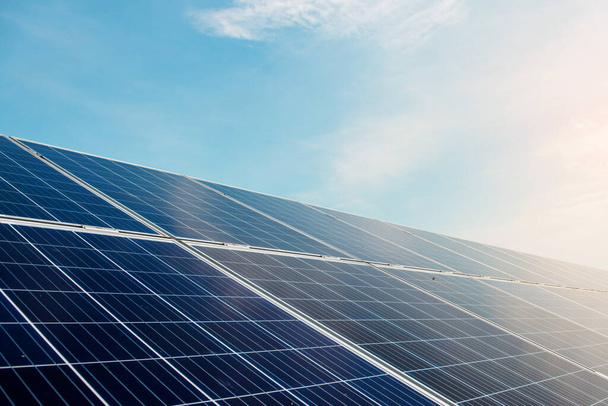 Photovoltaic power plant. Solar photovoltaic panels on blue sky background. Save the planet concept. Green energy concept. Solar energy industry - Φωτογραφία, εικόνα