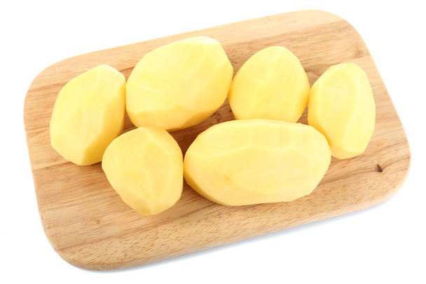 Raw peeled potatoes on wooden cutting board - Photo, Image