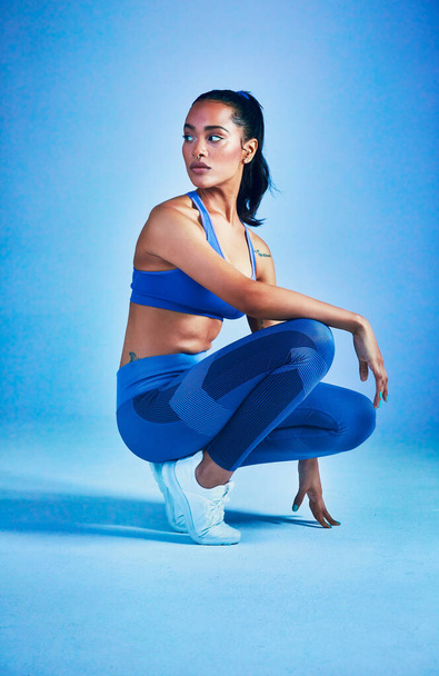 Shes in full workout mood. Full length shot of an attractive young sportswoman posing in studio against a blue background. - Φωτογραφία, εικόνα