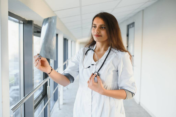 Medical concept of Indian beautiful female doctor in white coat with stethoscope, waist up. Medical student. - Φωτογραφία, εικόνα