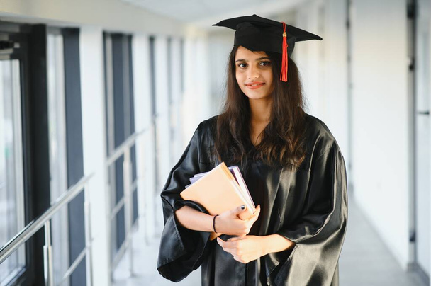 Young Asian Indian female graduate wearing robe. Achievement in life.Learning with confidence - Fotó, kép