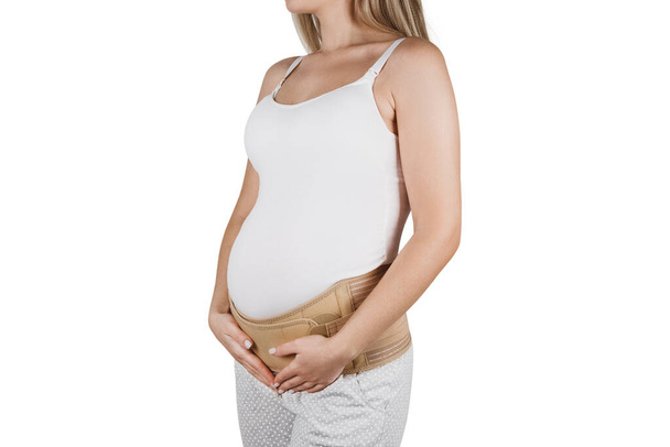 Pregnant woman belly in prenatal pregnancy maternity belt isolated on white background. Support waist, back, abdomen band. Belly Brace. Belly band for pregnancy. Orthopedic abdominal support belt - Fotoğraf, Görsel