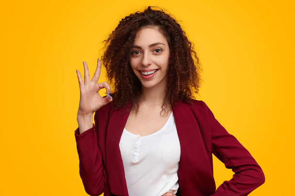 Smiling woman showing Ok gesture - Photo, image