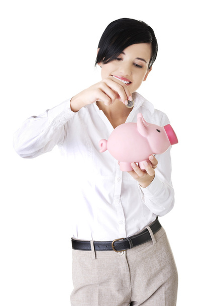 Happy businesswoman holding piggy bank - Foto, Imagen