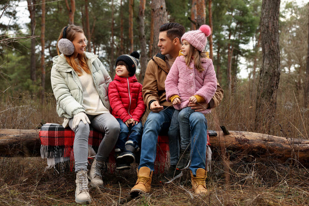 Happy family spending time together in forest - Фото, изображение