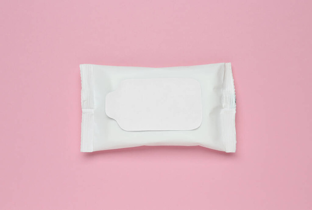 Wet wipes flow pack on pink background, top view - Valokuva, kuva