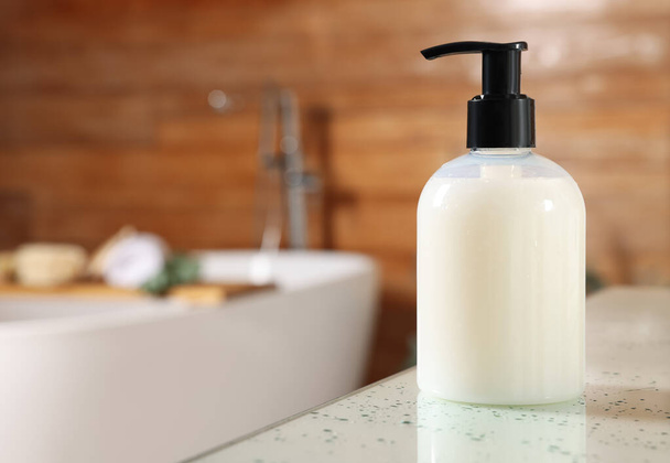 Dispenser of liquid soap on white table in bathroom, space for text - Foto, Imagem