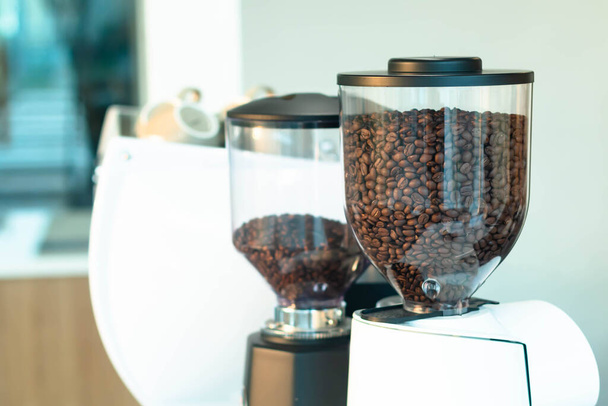 freshly roastd aromatic coffee beans over a modern machine  - Фото, изображение