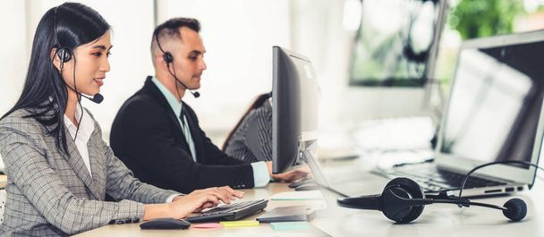 Business people wearing headset working in office broaden view - Foto, imagen