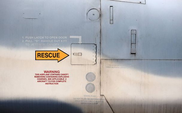 Rescue warning yellow arrow sign on fuselage of modern jet fighter - Photo, Image