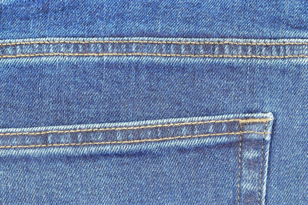 Detail van Achterzak van denim Jeans, Blue Jeans textuur vintage achtergrond. - Foto, afbeelding