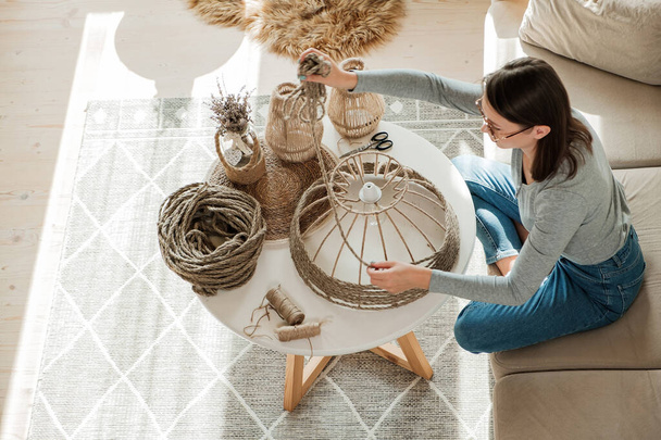 Woman makes handmade diy lamp from jute rope at home - Zdjęcie, obraz