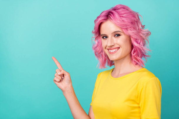 Photo of millennial cute pink hairstyle lady point empty space wear yellow t-shirt isolated on teal color background - Valokuva, kuva