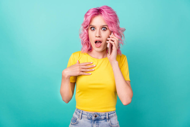 Photo of millennial looking pink hairdo lady talk telephone wear yellow t-shirt isolated on teal background - Fotó, kép