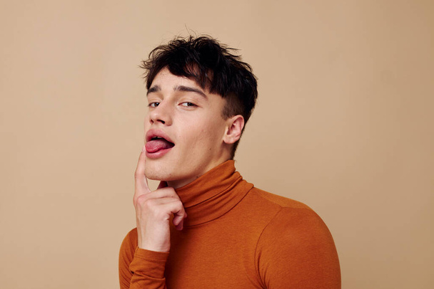 A young man stylish hairstyle brown turtleneck isolated background unaltered - Fotografie, Obrázek
