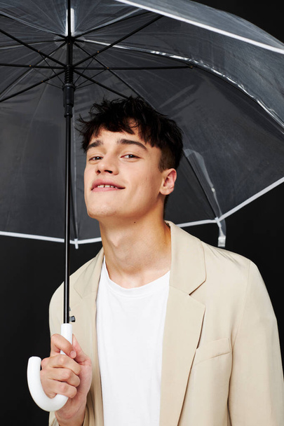 guy with transparent open umbrella suit elegant style - 写真・画像