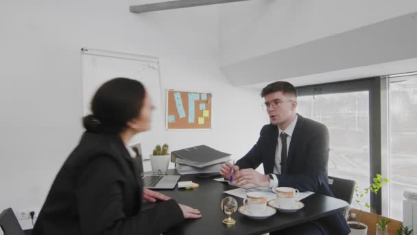 A business man and a woman, sitting at a table and solving business issues. Business people - Footage, Video
