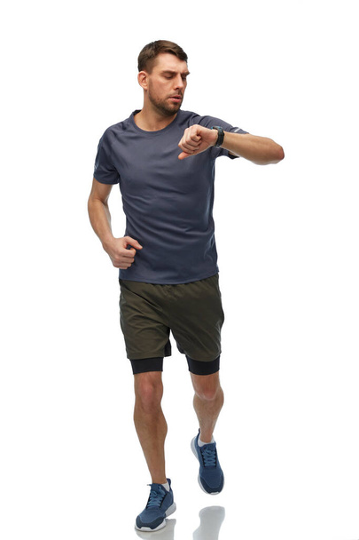 running man in sports clothes with smart watch - Φωτογραφία, εικόνα