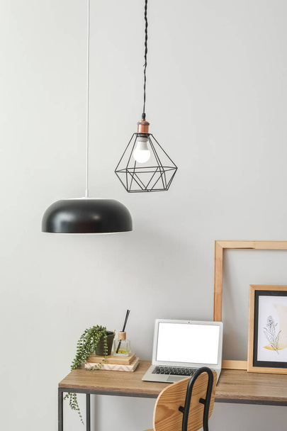 Stylish workplace with hanging pendant lamps in light room - Φωτογραφία, εικόνα