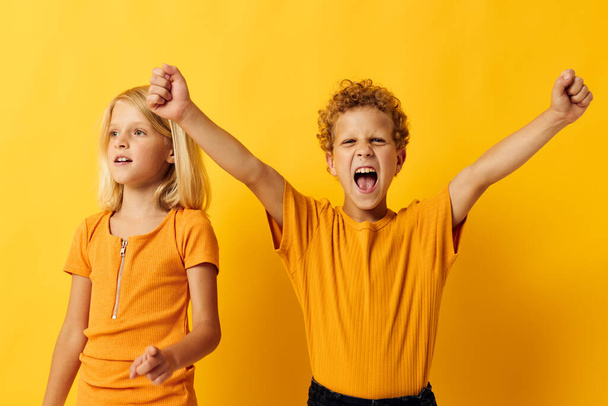 picture of positive boy and girl casual wear games fun together posing on colored background - Fotografie, Obrázek