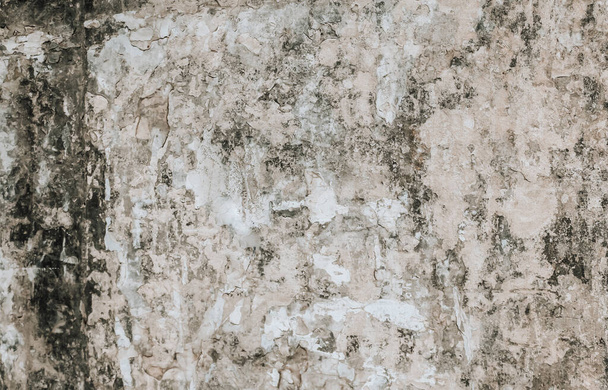 A weathered and damaged painted wall background. A dirty old plaster wall texture. - Fotografie, Obrázek