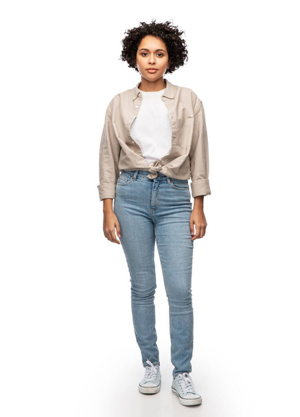 woman in shirt and jeans over white background - Valokuva, kuva