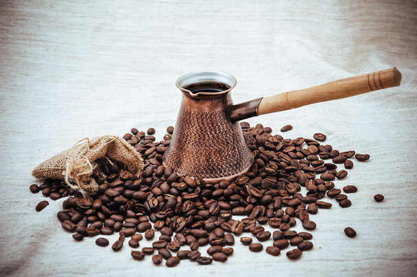 Coffee turk on burlap background. coffee beans isolated on white background. roasted coffee beans - 写真・画像