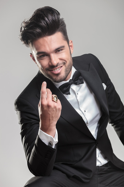 Handsome young man in tuxedo smiling for the camera - Фото, изображение