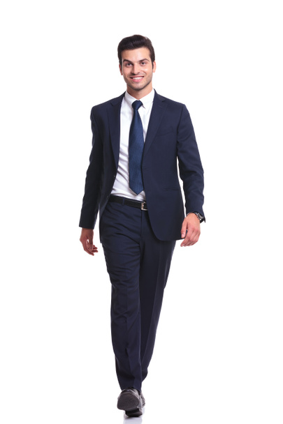 Happy business man walking on white studio background - Photo, Image