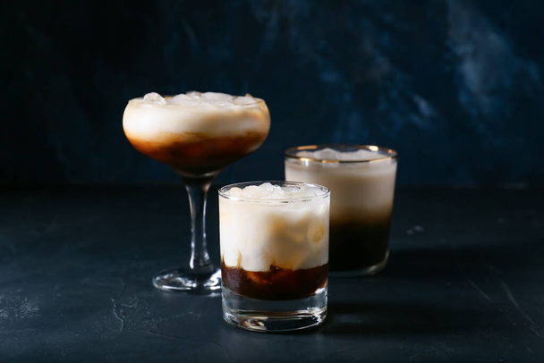 Glasses of White Russian cocktail on dark background - Фото, изображение