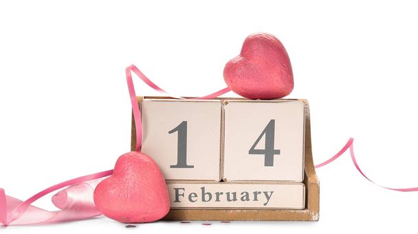 Calendar with date of Valentines Day and plastic hearts on white background - Photo, Image