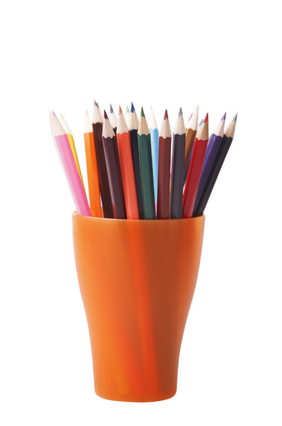 Colored pencils in an orange glass - Valokuva, kuva