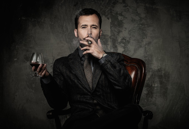 Handsome well-dressed with glass of beverage and cigar - Photo, Image